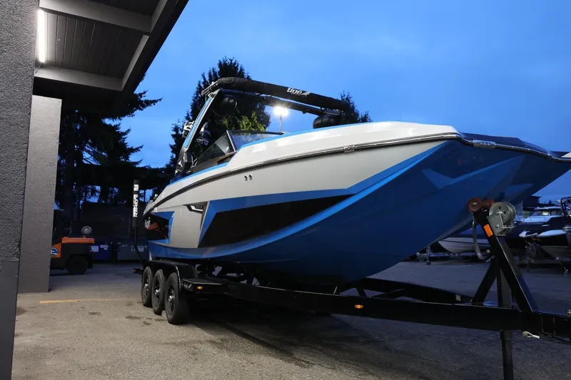 Slide: The Image of 2022 Tigé 24RZX boat on trailer at dusk, showcasing sleek design and vibrant colors. - 53
