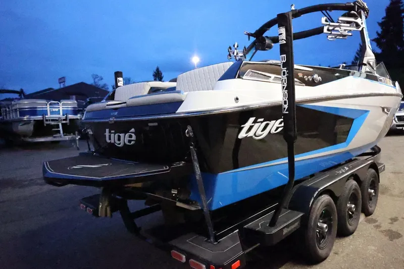Slide: The Image of 2022 Tigé 24RZX boat on trailer at dusk, showcasing sleek design and vibrant colors. - 63