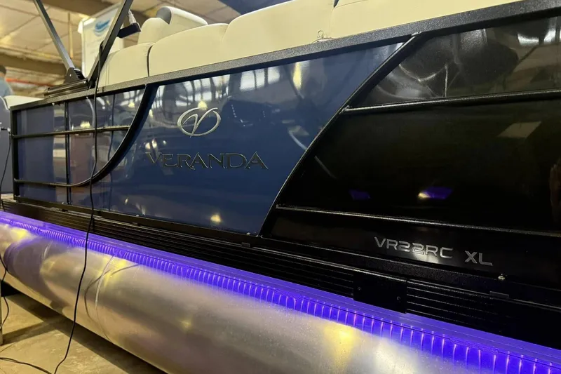 Slide: The Image of 2025 Veranda Relax VR 22 RC pontoon boat with illuminated underglow lighting. - 3