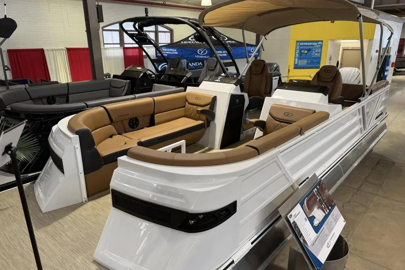 The Image of 2025 Veranda VX 25 DCVL pontoon boat with luxurious seating and canopy displayed indoors. - 0
