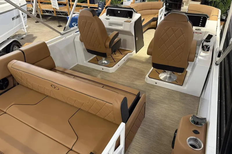 Slide: The Image of 2025 Veranda VX 25 DCVL boat interior with luxurious tan seating and modern helm. - 5