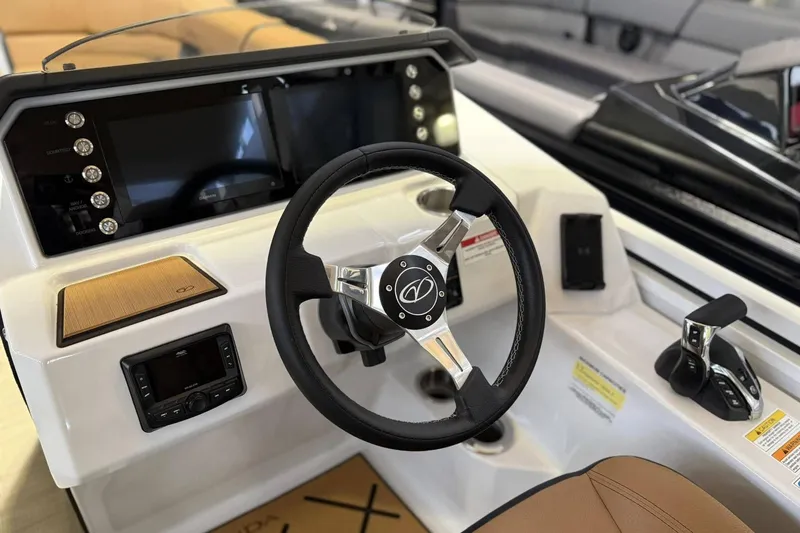 Slide: The Image of 2025 Veranda VX 25 DCVL boat dashboard with steering wheel and control panel. - 6