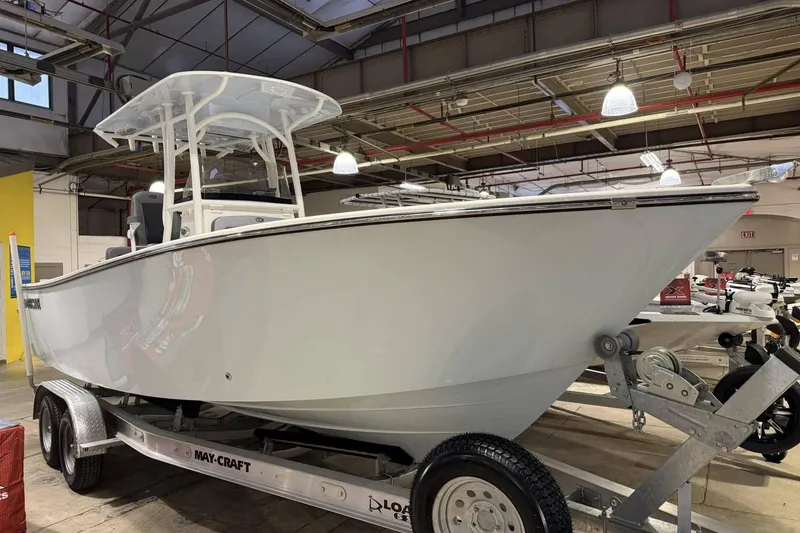 Slide: The Image of 2025 Defiance Catalina 240 boat on trailer in indoor showroom. - 12