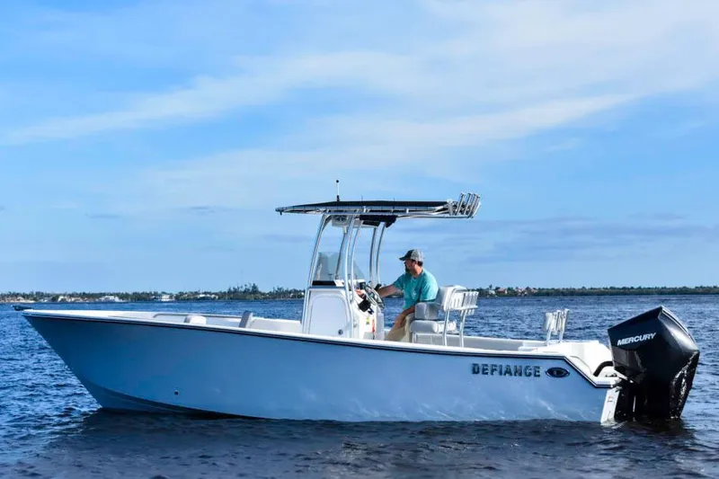 Slide: The Image of Manufacturer Provided Image: 2025 Defiance Catalina 240 boat cruising on open water with Mercury outboard engine. - 16