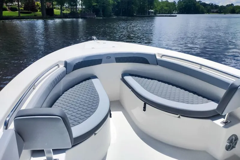 Slide: The Image of Manufacturer Provided Image: 2025 Defiance Catalina 240 boat with cushioned seating on a calm lake. - 18