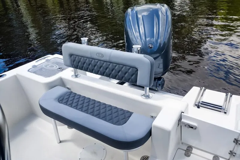 Slide: The Image of Manufacturer Provided Image: 2025 Defiance Catalina 240 boat with cushioned seating and outboard motor on calm water. - 20