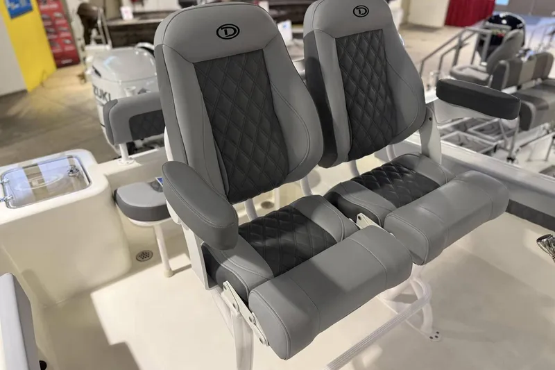 Slide: The Image of Luxury seating on 2025 Defiance Catalina 240 boat, featuring quilted gray upholstery. - 6