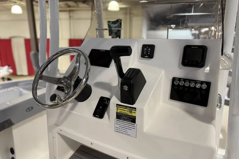 Slide: The Image of 2025 Defiance Catalina 240 boat dashboard with steering wheel and control panel. - 8