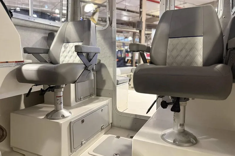 Slide: The Image of Interior of 2025 Defiance Admiral 220 EX boat with two cushioned seats. - 11