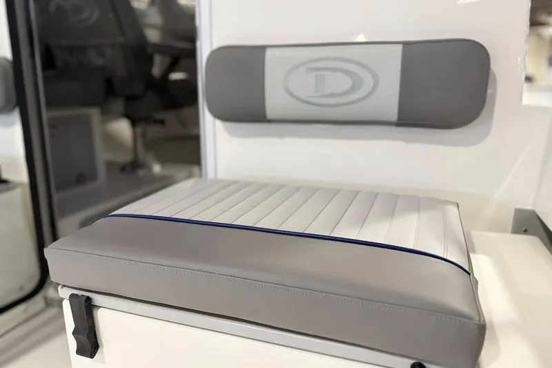 Slide: The Image of 2025 Defiance Admiral 220 EX boat seat with gray and white cushioned design. - 12