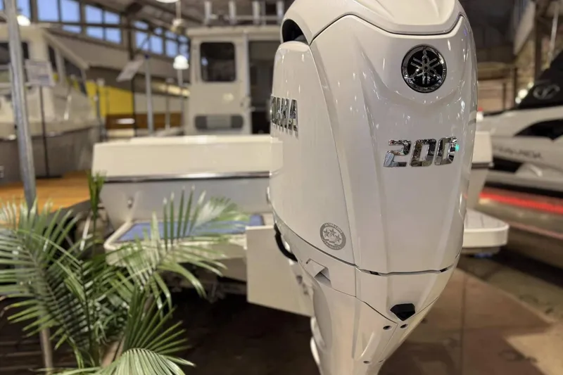 Slide: The Image of 2025 Defiance Admiral 220 EX with Yamaha 200 outboard motor in showroom. - 15
