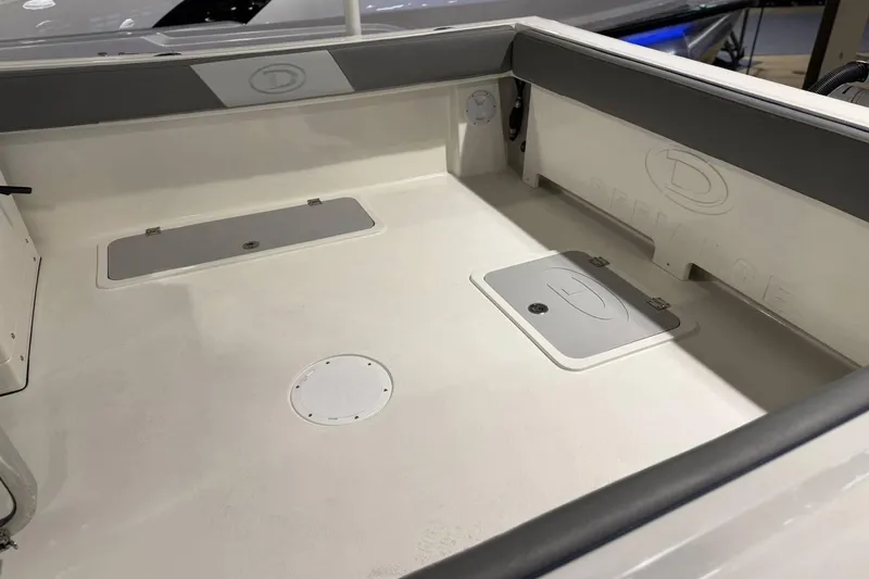 Slide: The Image of 2025 Defiance Admiral 220 EX boat interior with storage compartments and sleek design. - 17