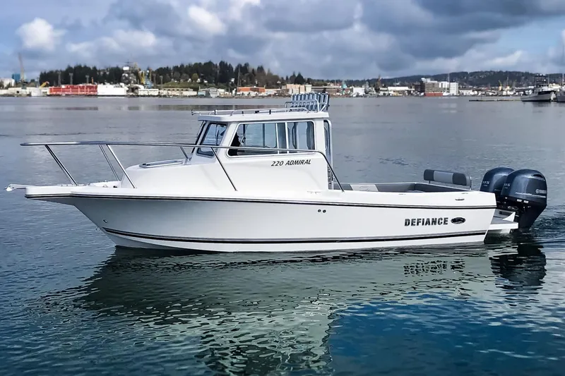 Slide: The Image of Manufacturer Provided Image: 2025 Defiance Admiral 220 EX boat on calm water under cloudy sky. - 18