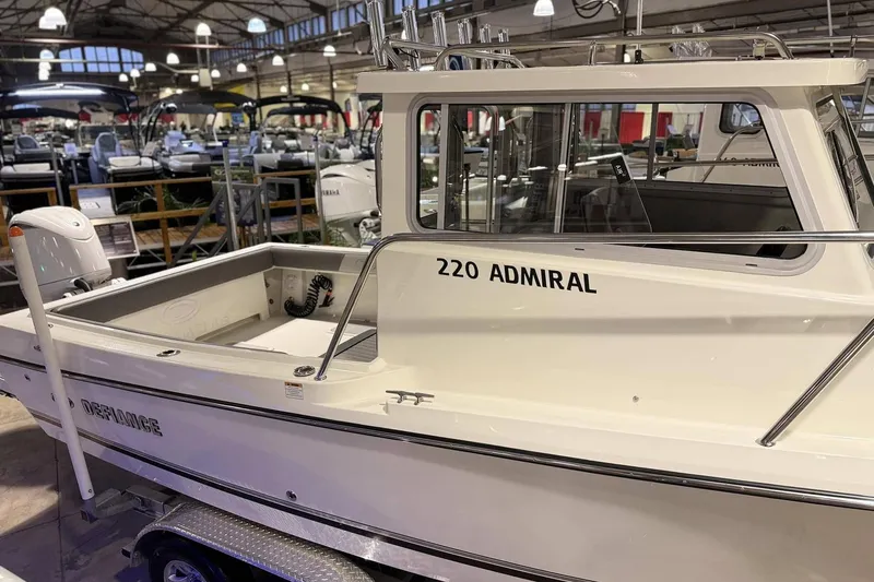 Slide: The Image of 2025 Defiance Admiral 220 EX boat displayed in a showroom, showcasing sleek design. - 4