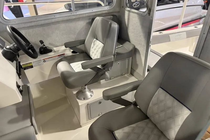 Slide: The Image of Interior of 2025 Defiance Admiral 220 EX boat with modern seating and steering wheel. - 7