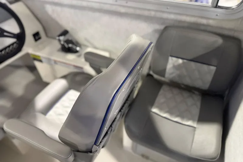 Slide: The Image of Interior seating of 2025 Defiance Admiral 220 EX boat, featuring gray cushioned seats. - 8