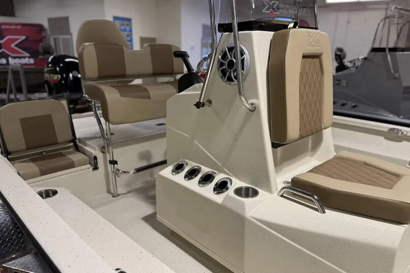 Slide: The Image of 2025 Xpress H20B Bay boat interior with beige seating and console details. - 2