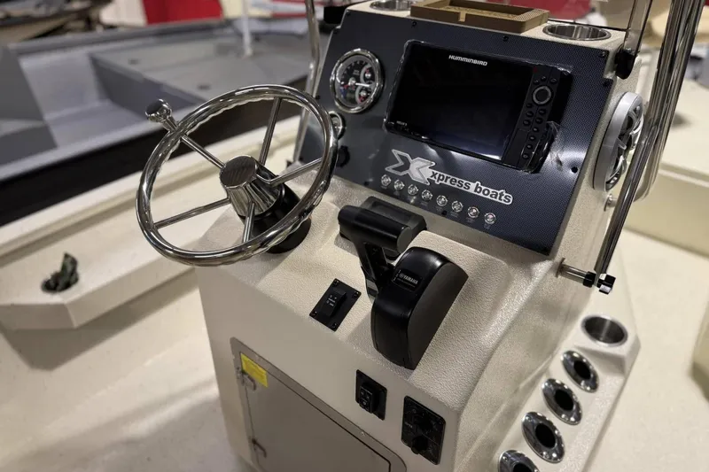 Slide: The Image of 2025 Xpress H20B Bay boat console with steering wheel and navigation controls. - 3