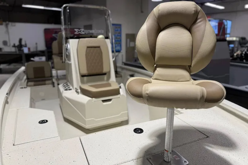 Slide: The Image of 2025 Xpress H20B Bay boat interior with beige seating and console. - 4