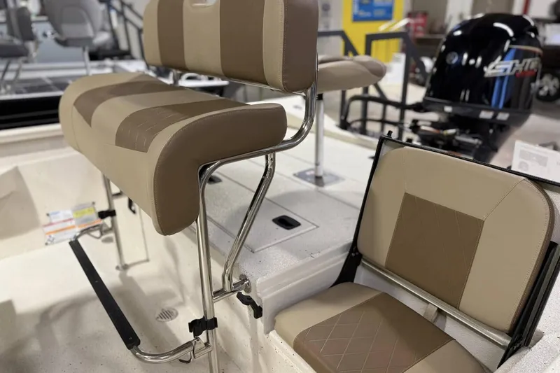 Slide: The Image of 2025 Xpress H20B Bay boat interior with tan seating and stainless steel frames. - 7