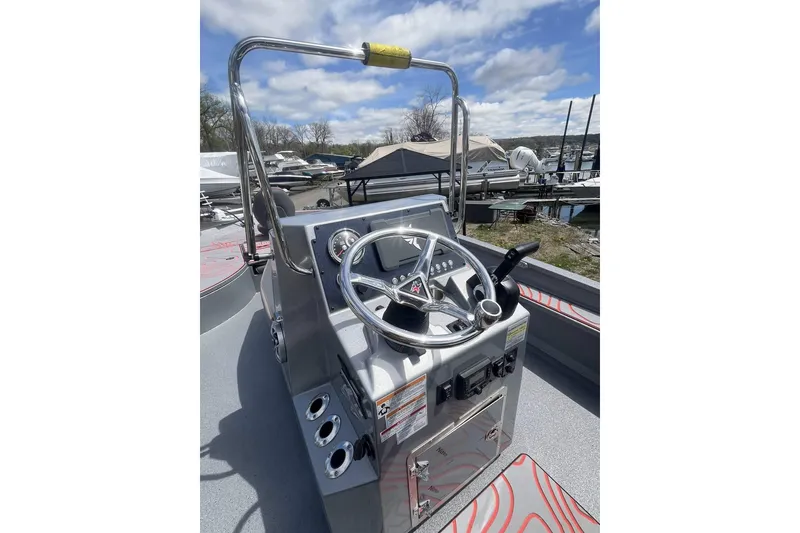 Slide: The Image of 2025 Xpress X23B Bay Lounge boat console with steering wheel and controls. - 3