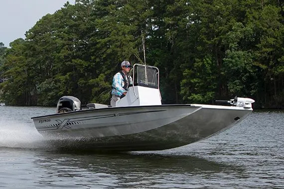 The Image of 2025 Xpress H190B Bay boat on trailer in showroom, featuring sleek design and modern equipment. - 0