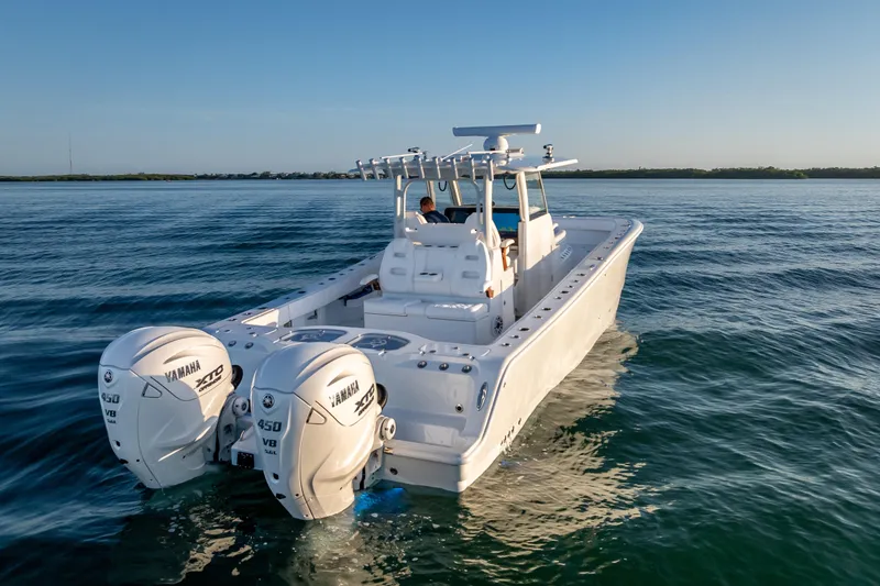 Slide: The Image of 2026 Freeman 35 boat with twin Yamaha 450 engines cruising on calm water. - 14