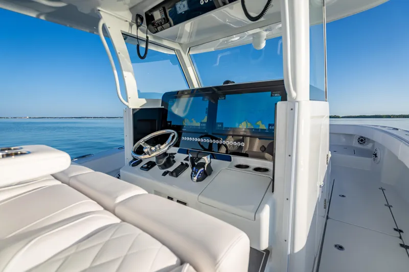 Slide: The Image of Modern Freeman 35 boat cockpit with advanced navigation system, 2026 model, on calm waters. - 19