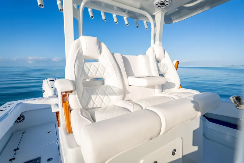 Slide: The Image of Luxurious seating on a 2026 Freeman 35 boat, with a serene ocean backdrop. - 25