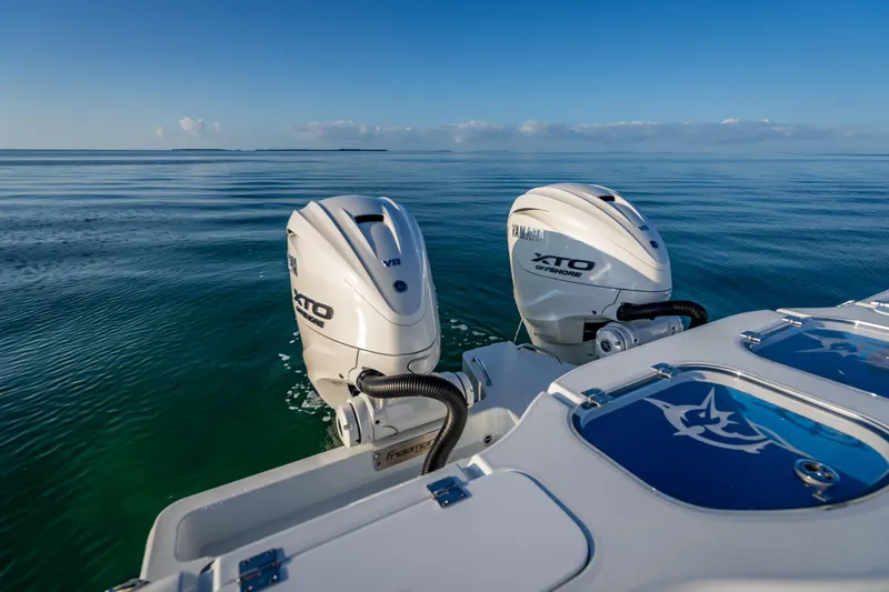 Slide: The Image of Twin Yamaha XTO engines on a 2026 Freeman 35 boat, cruising on calm ocean waters. - 29