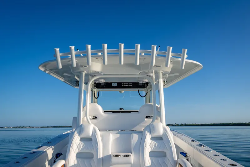 Slide: The Image of 2026 Freeman 35 boat with sleek design on calm water under clear blue sky. - 34