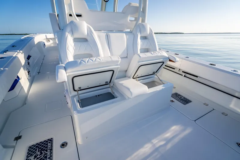 Slide: The Image of Luxurious seating on a 2026 Freeman 35 boat, featuring white leather and storage compartments. - 35