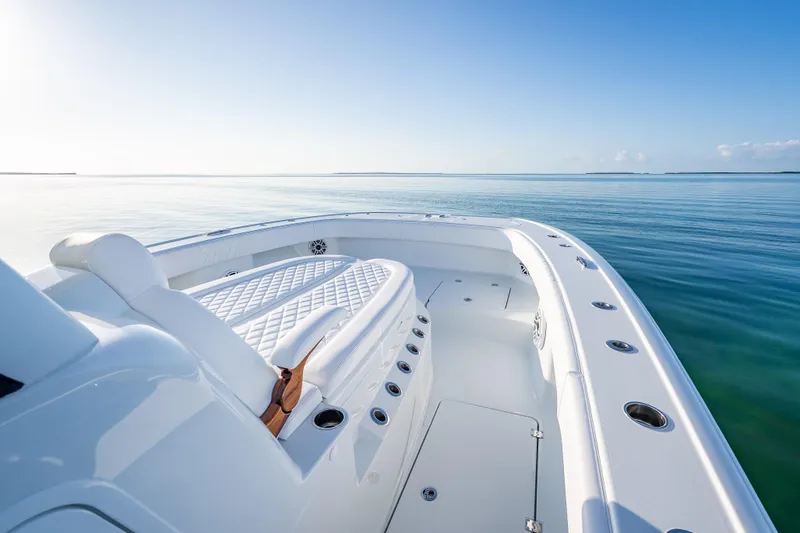 Slide: The Image of 2026 Freeman 35 boat on calm ocean, featuring sleek white deck and seating. - 37