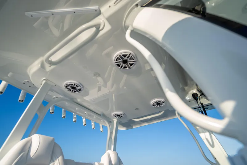 Slide: The Image of 2026 Freeman 35 boat interior with speakers and rod holders against blue sky. - 48