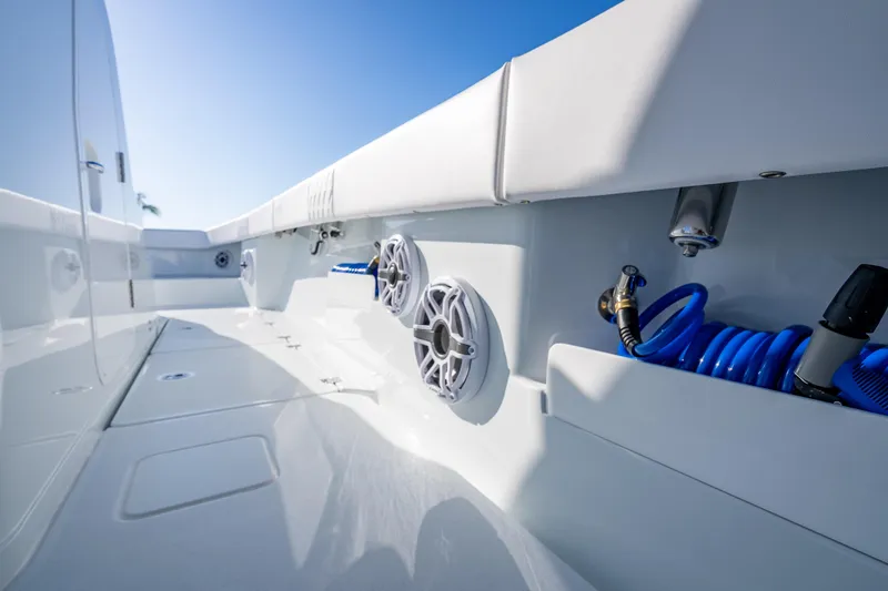 Slide: The Image of 2026 Freeman 35 boat deck with speakers and coiled hose under clear blue sky. - 51
