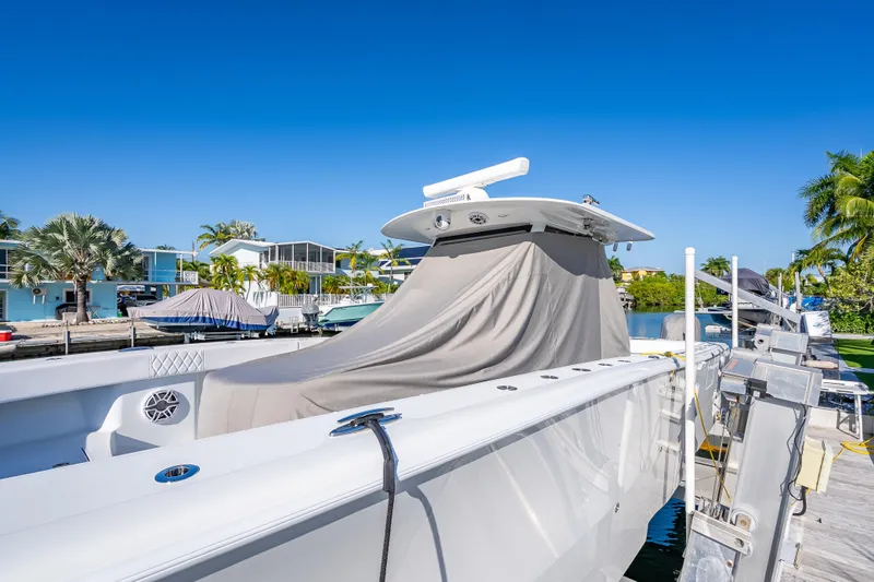 Slide: The Image of 2026 Freeman 35 boat docked, covered, with clear blue sky and tropical surroundings. - 56