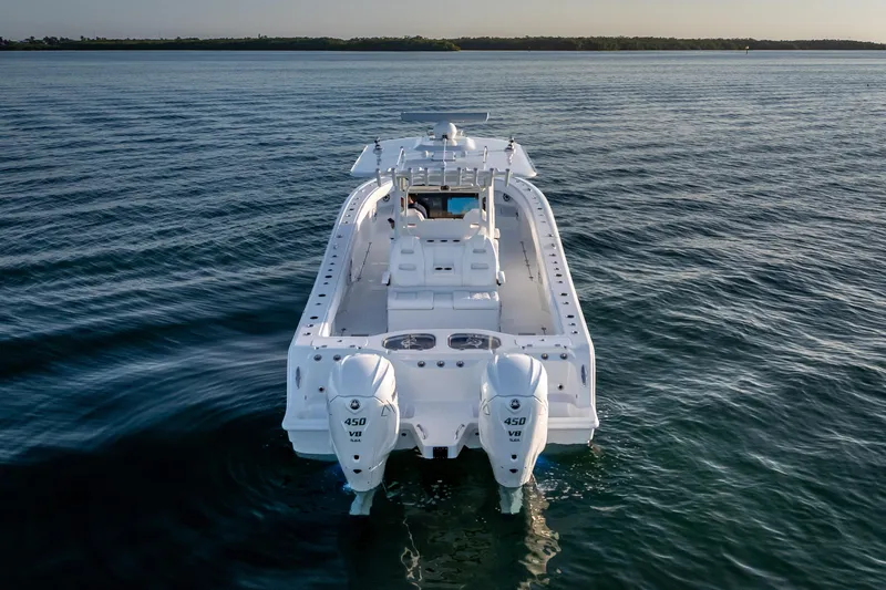 Slide: The Image of 2026 Freeman 35 boat on calm water, rear view with dual engines. - 9