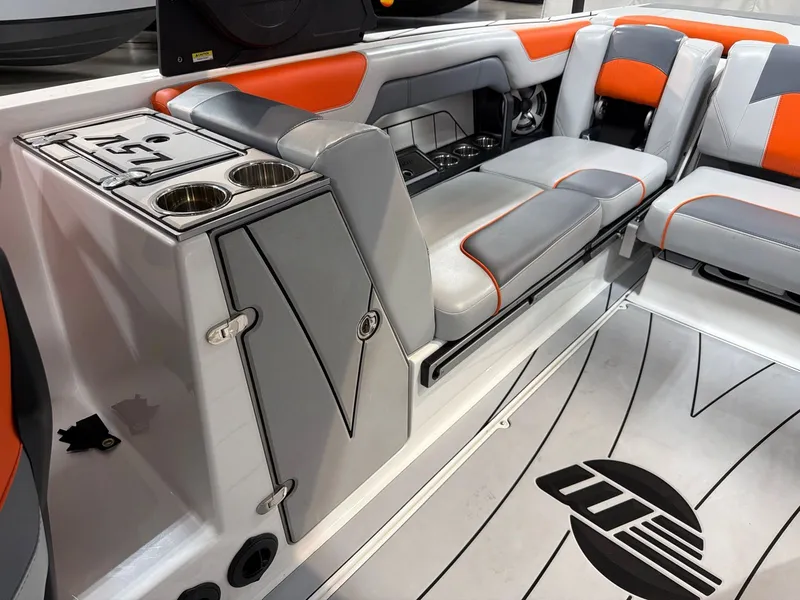 Slide: The Image of Interior of 2021 Malibu Wakesetter 25 LSV with gray and orange seating. - 14