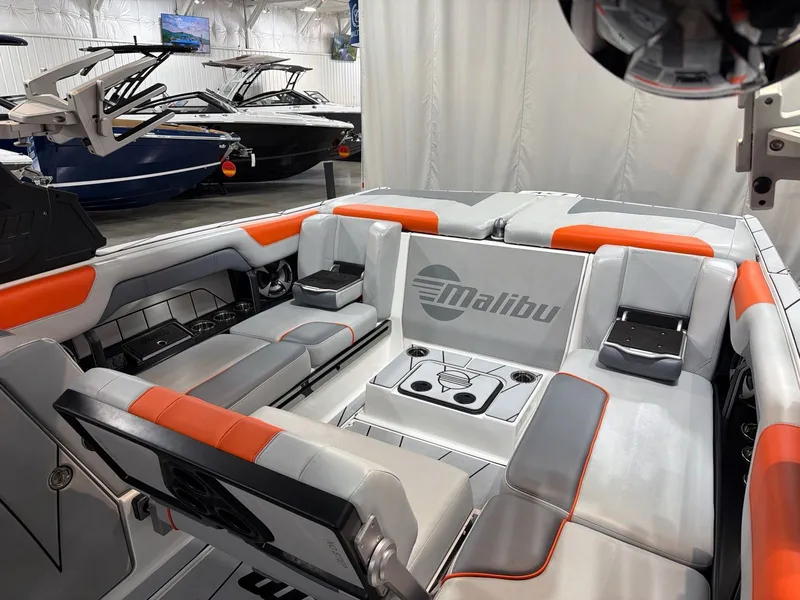 Slide: The Image of Interior of 2021 Malibu Wakesetter 25 LSV with gray and orange seating. - 16