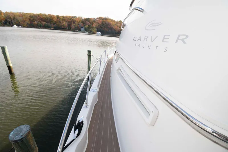 Slide: The Image of 2007 Carver 43 Motor Yacht docked by a serene lake. - 16