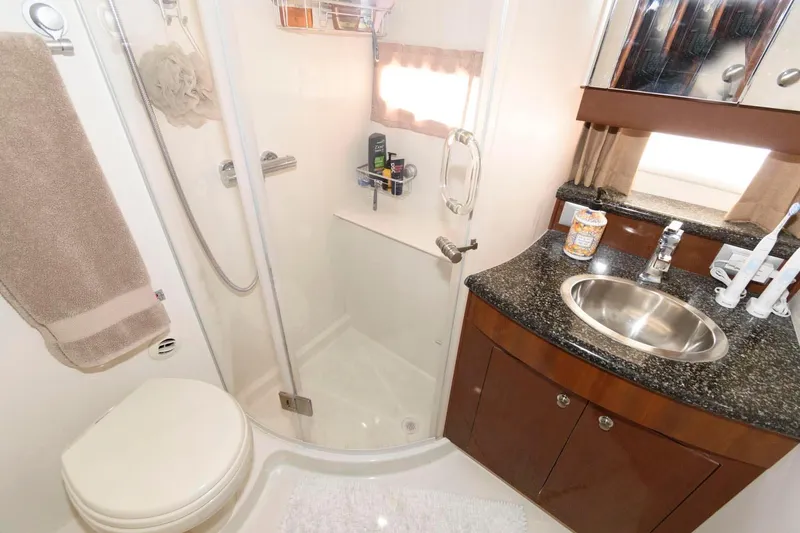 Slide: The Image of 2007 Carver 43 Motor Yacht bathroom with shower, sink, and toilet. - 27