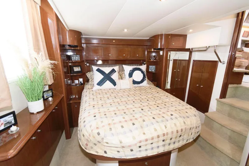 Slide: The Image of Luxurious bedroom interior of 2007 Carver 43 Motor Yacht with cozy bed and wooden cabinetry. - 25