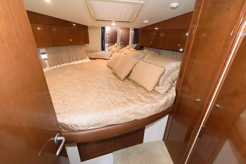 Slide: The Image of Luxurious bedroom in a 2007 Carver 43 Motor Yacht with plush bedding and wooden cabinetry. - 28