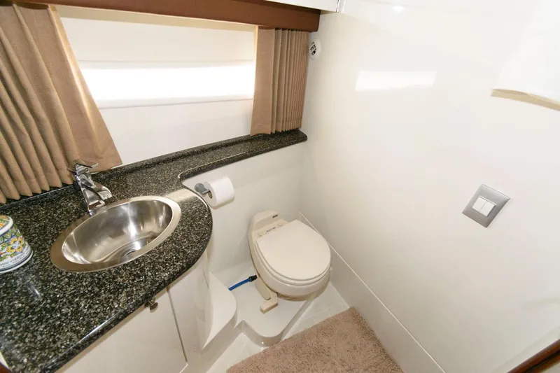 Slide: The Image of Luxurious bathroom in 2007 Carver 43 Motor Yacht with granite countertop and stainless steel sink. - 29