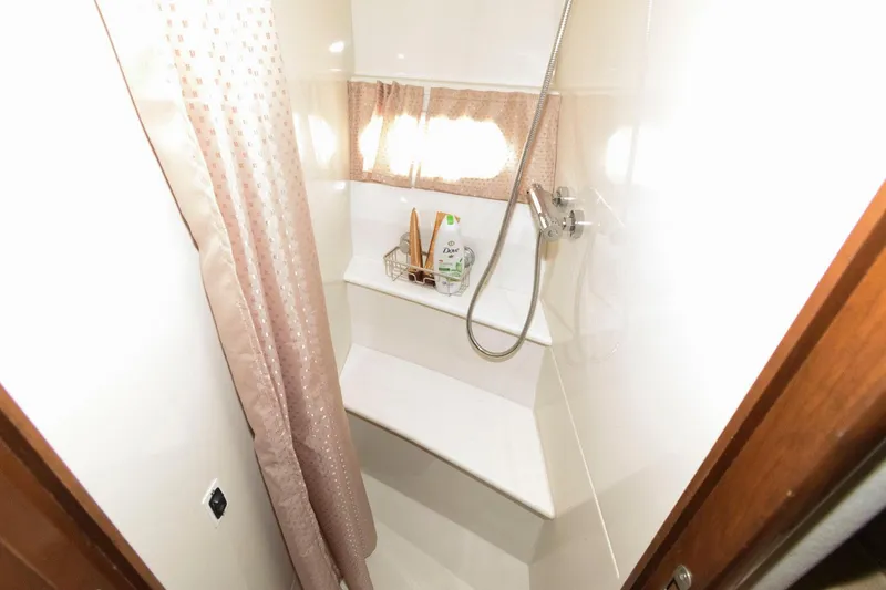 Slide: The Image of 2007 Carver 43 Motor Yacht shower with bench and curtain. - 30