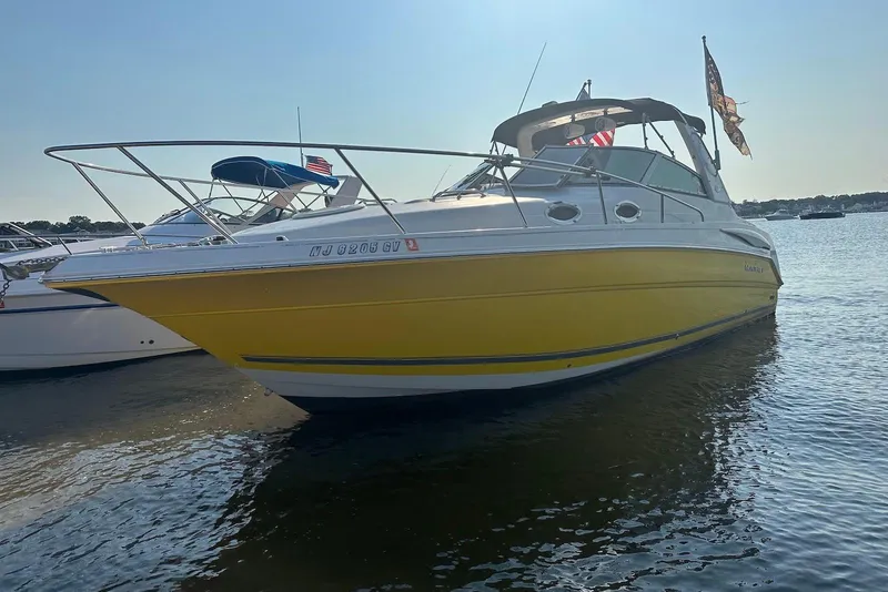 The Image of 2004 Monterey 282 Cruiser boat with yellow hull on calm water. - 0