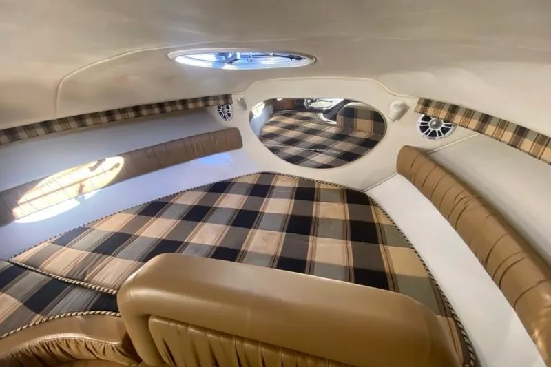 Slide: The Image of Interior of 2004 Monterey 282 Cruiser with plaid upholstery and circular window. - 11