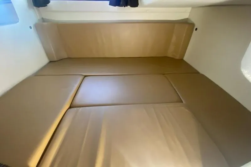 Slide: The Image of 2004 Monterey 282 Cruiser cabin interior with beige cushions. - 14