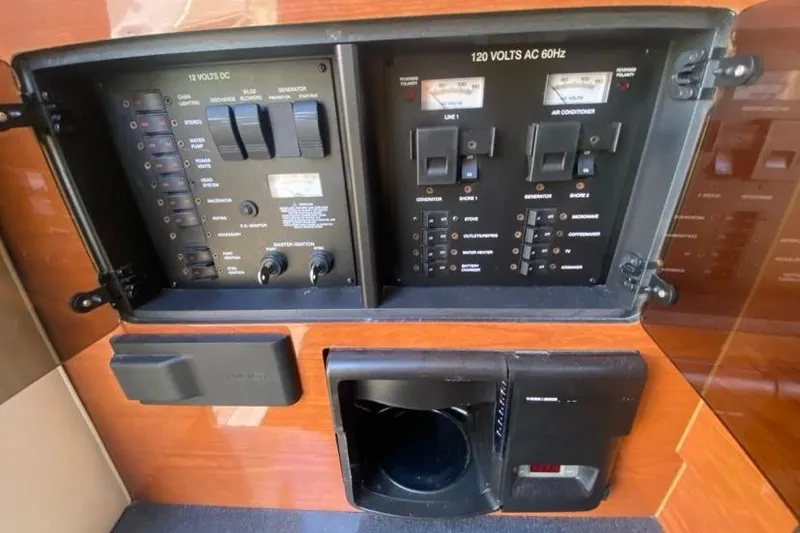 Slide: The Image of Control panel of a 2004 Monterey 282 Cruiser boat, featuring electrical switches and gauges. - 16