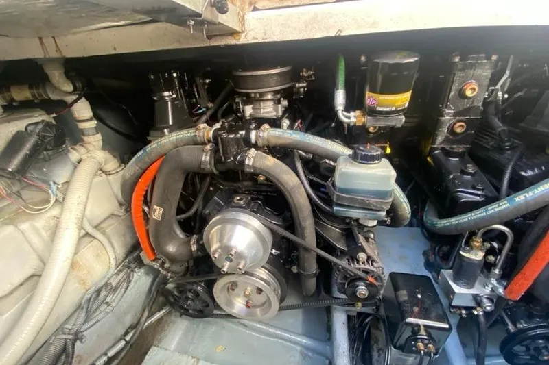 Slide: The Image of Engine compartment of a 2004 Monterey 282 Cruiser, showcasing mechanical components and hoses. - 18